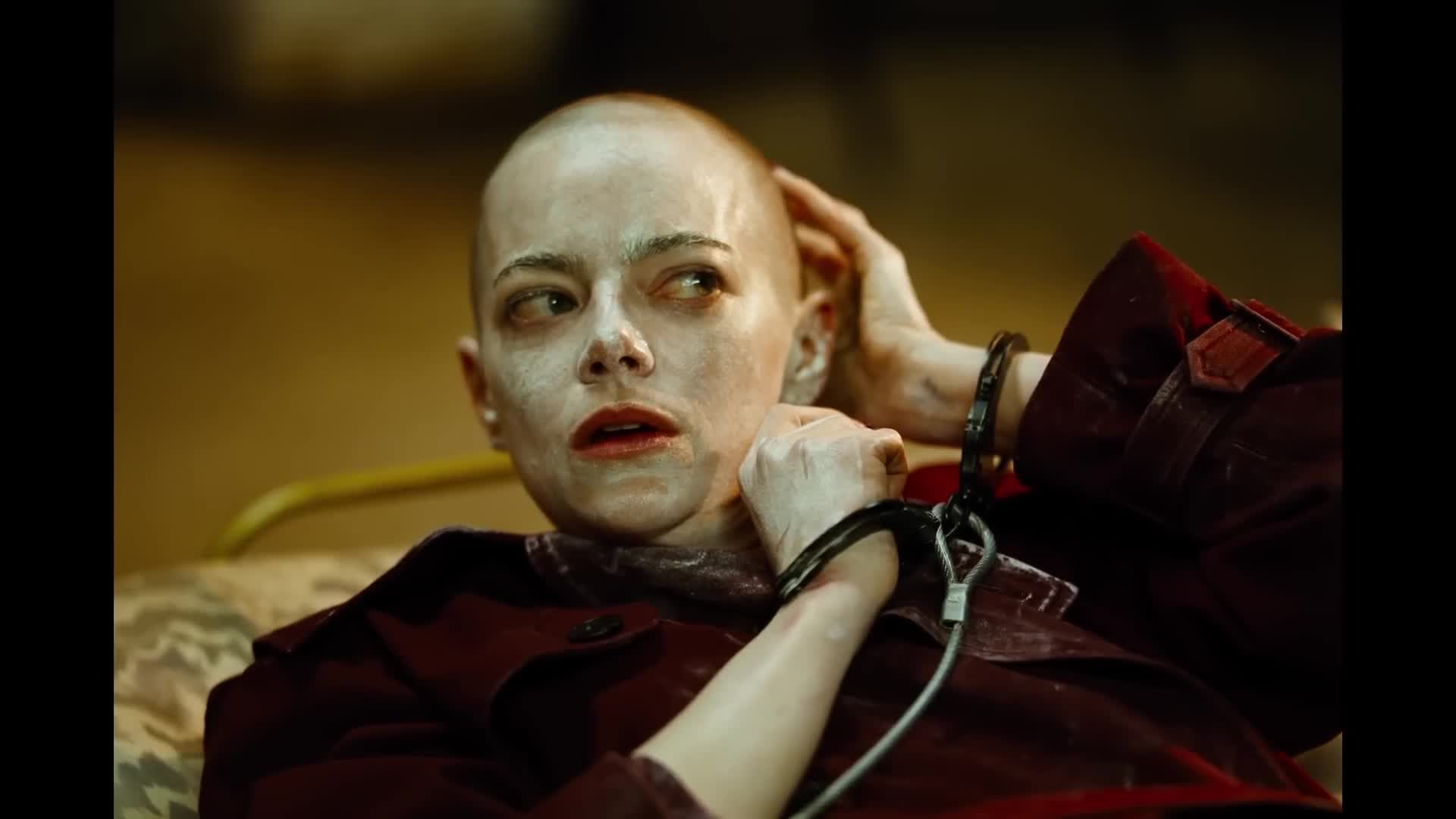 still from Bugonia - Emma Stone has been shaved bald and rubbed with lotion